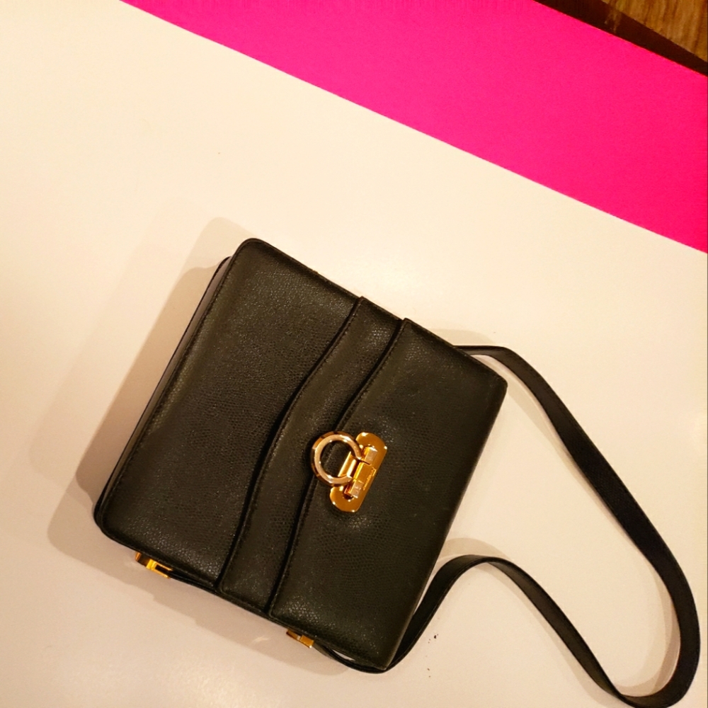 Black leather Ferragamo handbag with strap.